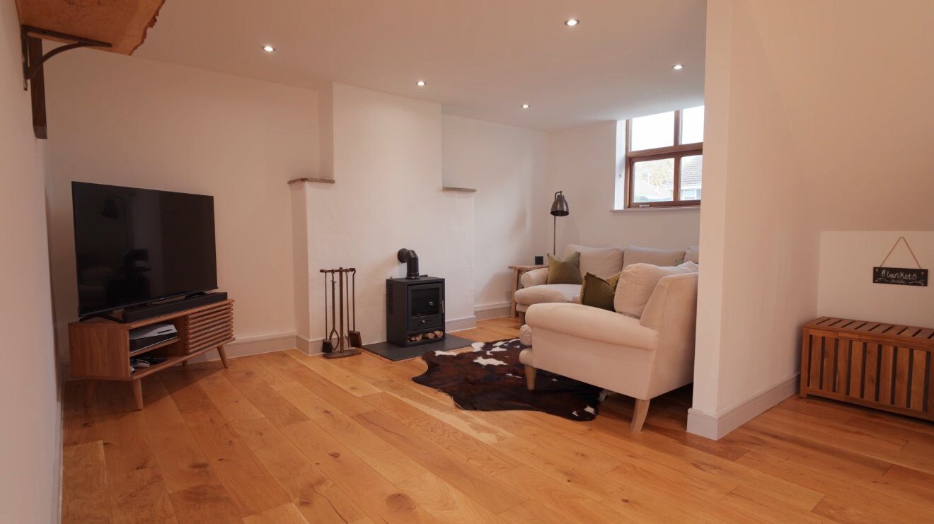 Cosy living room with wood burner and oak floors