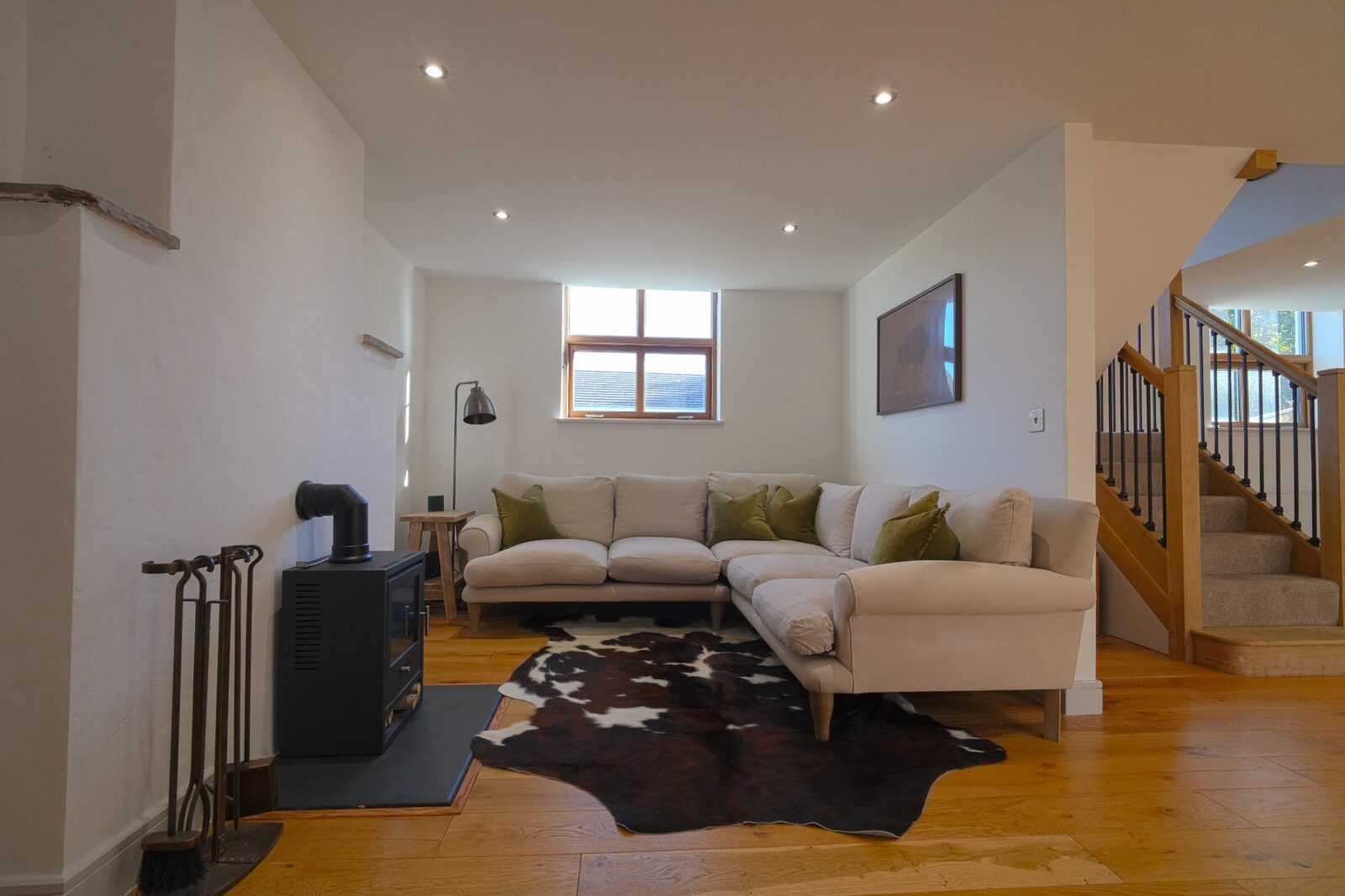 Corner sofa with wood burner and staircase