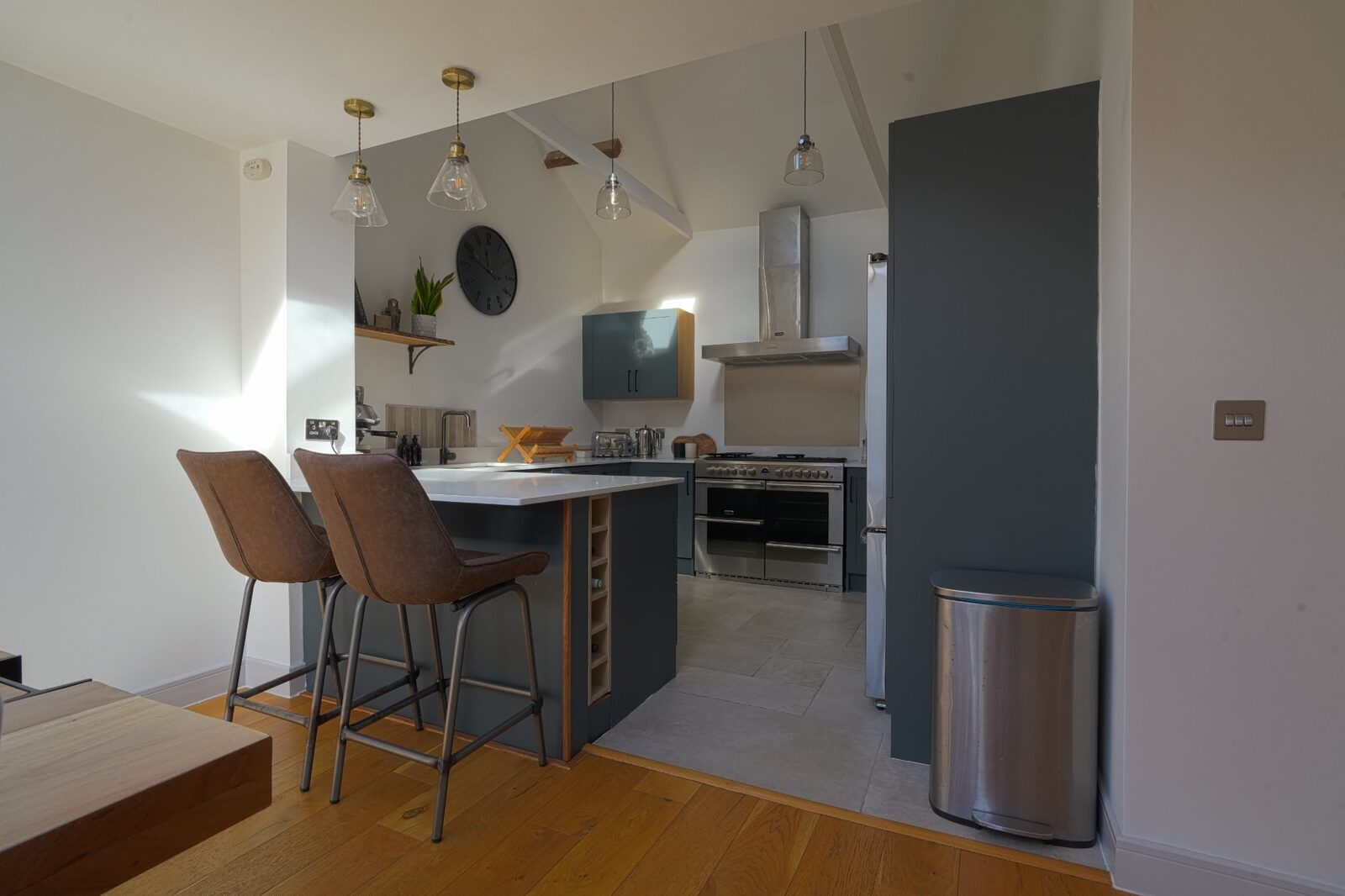 Kitchen with breakfast bar and pendant lights