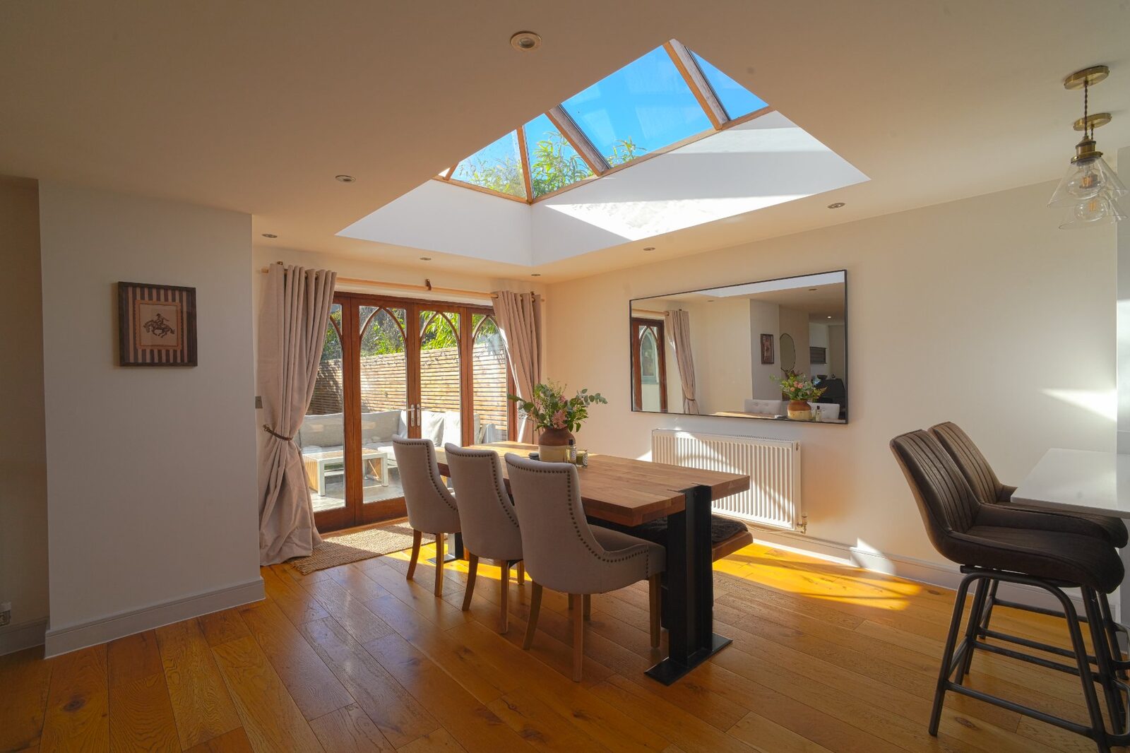 Dining table with Gothic doors leading to garden
