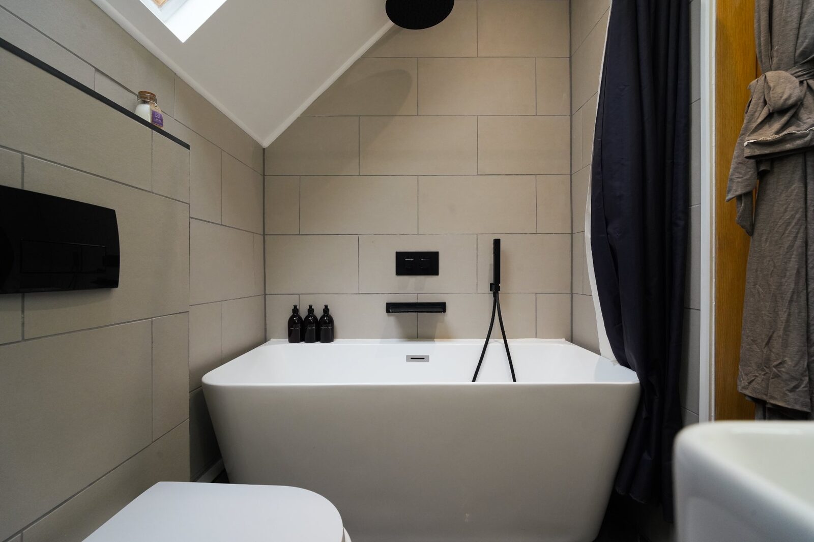 Freestanding bath with black fixtures